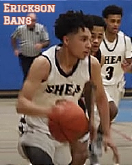 Rhode Island boys basketball player shown with ball moving up the court for the Shea High School team.