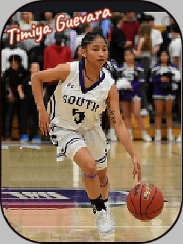 Image of girls basketball player Timiya Guevra, Denver South High School in Colorado. Shown dribbling up court with left hand, in #5 SOUTH white uniform.