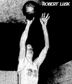 Image of Robert Lusk, basketball player on the Baileysville High School boys basketball team in West Virginia, #32, with basketball in both hands up in the air shooting. From The Raleigh Register, Beckley, West Virginia, December 18, 1969.