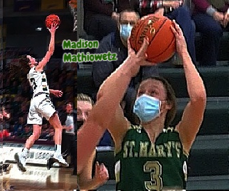 Pictures of MAdison Mathiewetz, Sleepy Eye St. Mary's girls basktball player in Minnesota. Up in air full body shot from side of putting up lay-up and shot in  green  number 3 jersey, shooting with mask on.