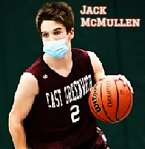 Picture, from belt up, of boys basketball player Jack McMullen, dribbling upcourt. with mask on, in black uniform #2, number and EAST GREENWICH in white.