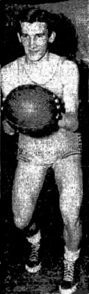 Image of Pat Stark, basketball player for Stracuse Vocational High School, N.Y., holding ball at chest level looking to pass. From The Post-Standard, Syracuse, New York, January 14, 1949.