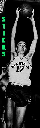 Image of boys basketball player, Bob (Sticks) Bolton, Lakeview High School, Michigan, in white #17 uniform, going high towards basket with basketball in both hands, in white SPARTANS uniform. From the Battle Creek Enquirer, BAttle Creek, Michigan, March 21, 2006.