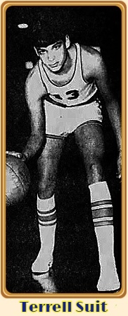 Image of Terrell Suit, boys basketball player on the T.L. Hanna High School (South Carolina), in uniform #13, crouched and dribbling towards us. From The Greenville News, Breenville, South Carolina, February 10, 1970.