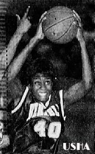 Usha Gilmore, state of South Carolina girls basketball player for Berkeley High School, #40, with ball over head, from above, shooting at basket. From The Greenville News, Greenville, South Carolina, March 24, 1996. Photo by Wade Spees.