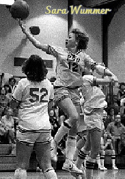 Image of girls basketball player, Sara Wummer, Pennsylvania School for the Deaf, #12, putting up a right-handed one-handed lay-up, high in the air.