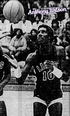 Image of Anthony Wilson, boys basketball player from the Plain Dealing Academy in Louisiana, in dark #10 LIONS uniform, looking up at the basketball in the air. From the Shreveport Journal, Shreveport, La., November 17, 1982. Photo by Ralph Fountain.