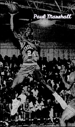 Image of boys basketball player, Paul Marshall, Southwood High School (Louisiana), number 24, in dark uniform, high in air, legs apart laying the ball in the basket with his right hand. From The Times, Shreveport, La., January 1, 1990. Photo by Mike Silva.