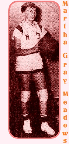 Photo of Martha Gray Meadows, in Hiddenite High School basketball uniform, capital H on right breat, #3 on the left, full image, standing, posing, facing to our right, holding basketball in front. From the Statesville Record and Landmark, Statesville, North Carolina, March 8, 1957.