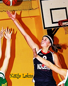 Image of Kitija Laksa, Kolibri-47.vsk C2 (Latvia) girls basketball player reaching up after releasing the ball towards the basket. girlsbasket.eu Foto.