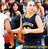 Michelle Woods, Wheelock College basketball player, dribbling ball, in gold on blue uniform, number 12.