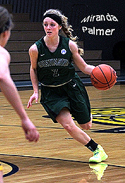 Miranda Palmer, Huntington University basketball player, dribbling the ball, charging in to shoot. Number 2.